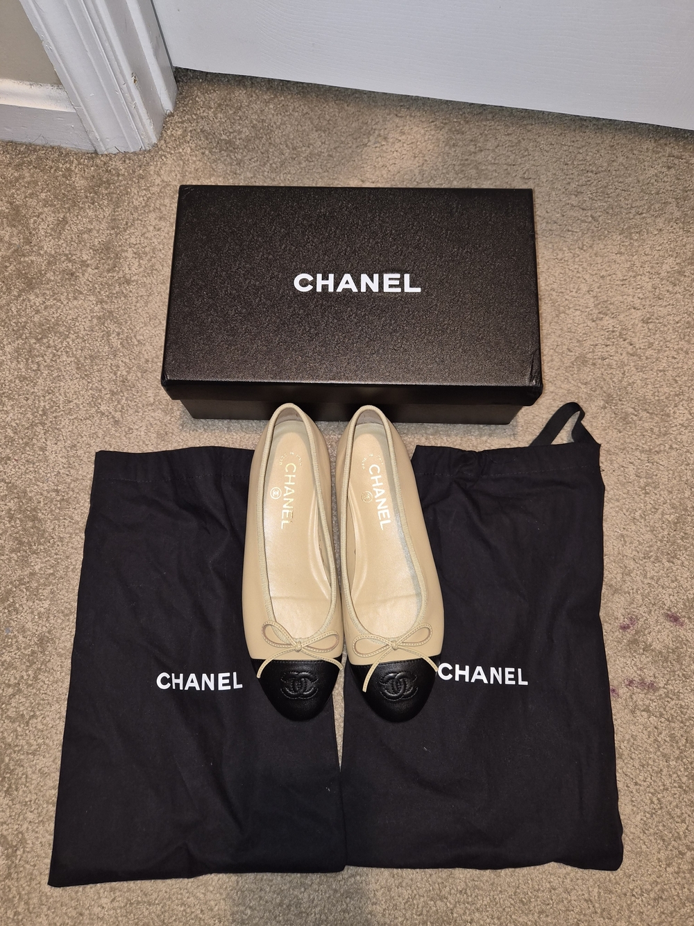 CHANEL Beige Leather Ballet Flats with Black Cap Toe and Bow
